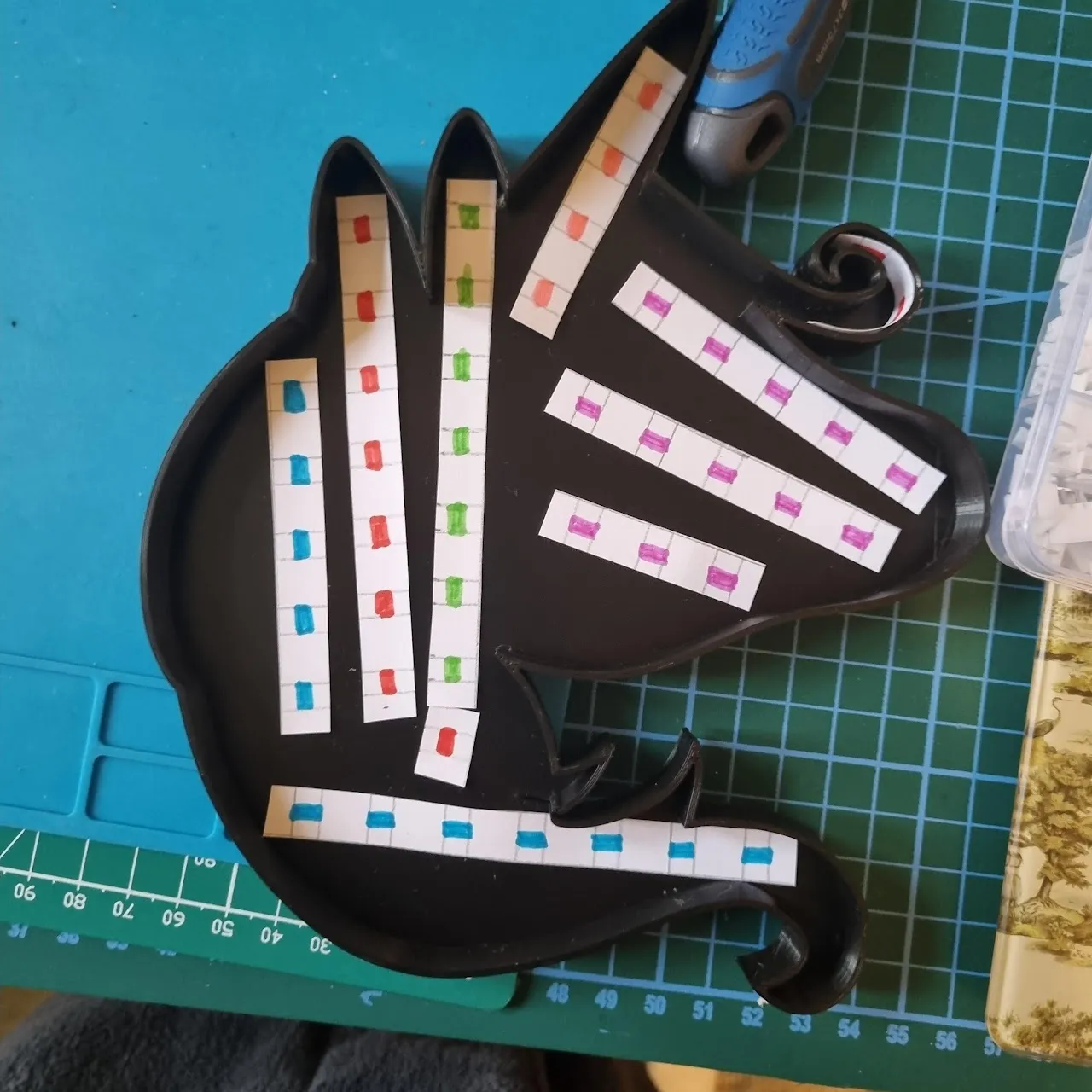 Using paper strips to plan the layout of the LED strips.